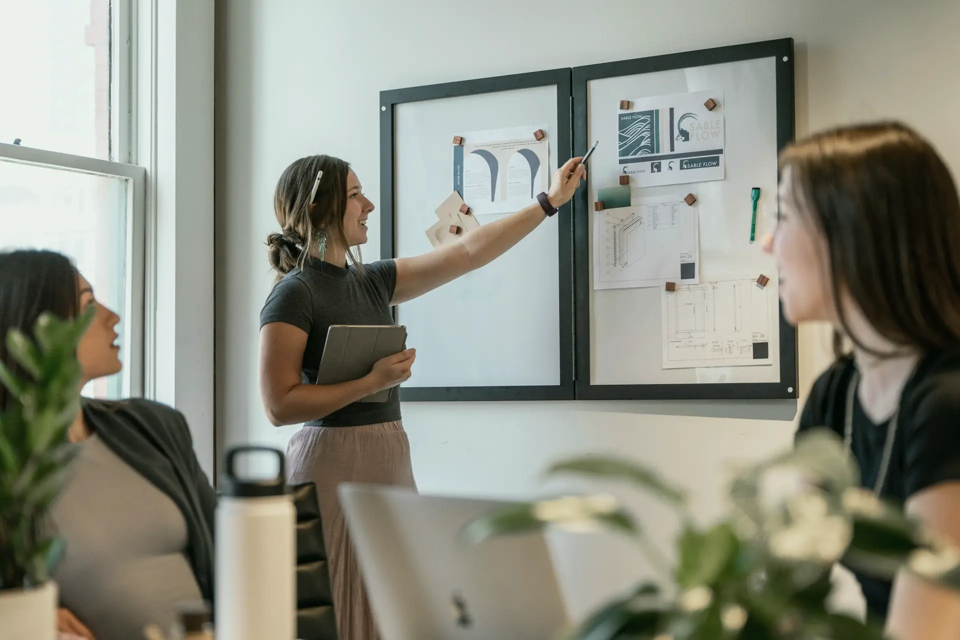 A team discussing a plan at a whiteboard
