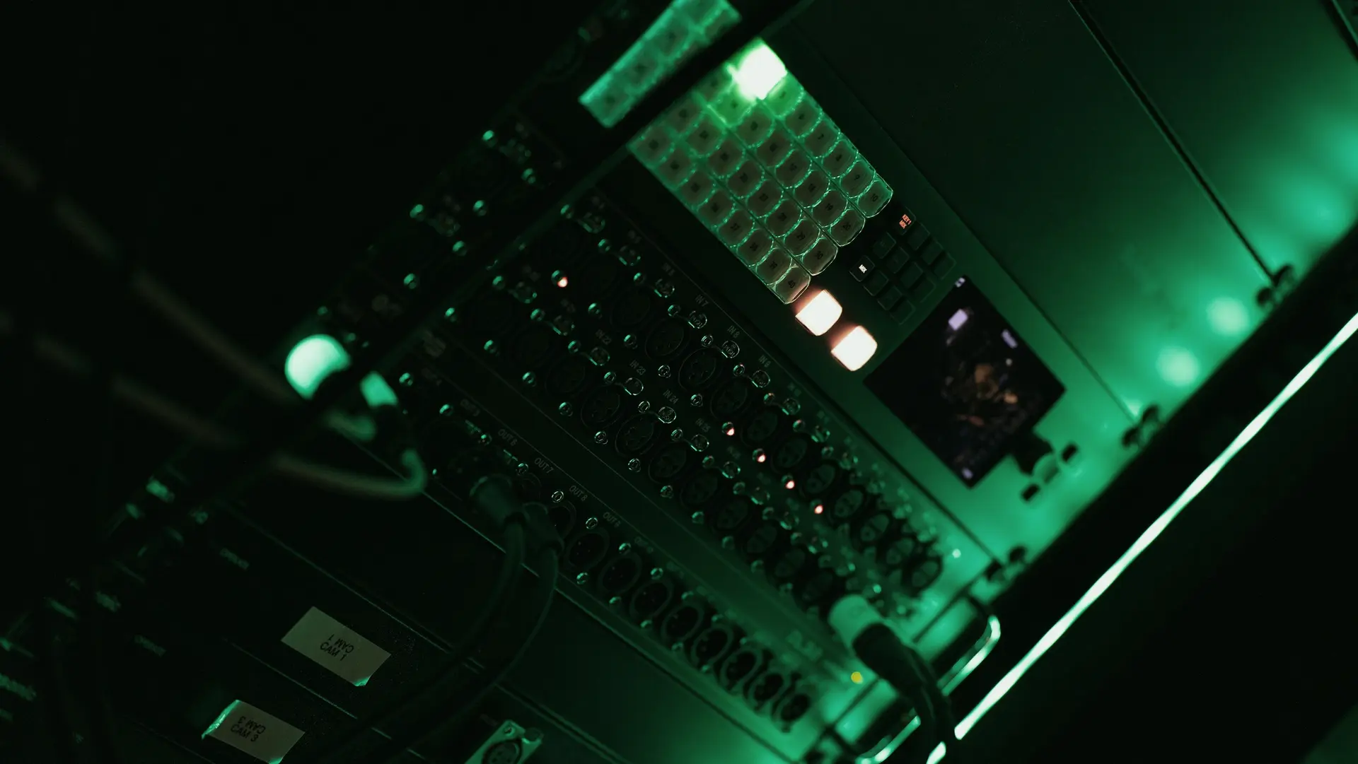 Server hardware glowing green in a dark equipment room